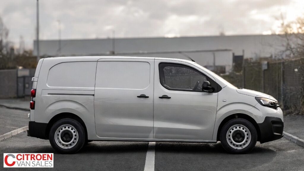 Crew cab van with rear passenger windows parked near a work site, showing the people-and-tools layout concept.